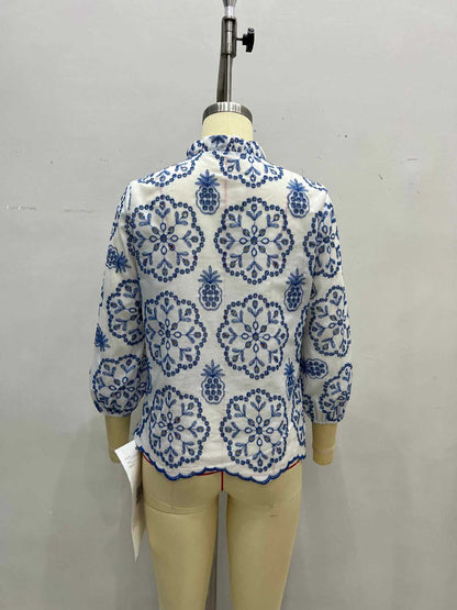 Blue and White Floral Blouse with Ruffled Collar and Scalloped Hem